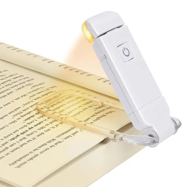 Reading lamp illuminating a book on a white background