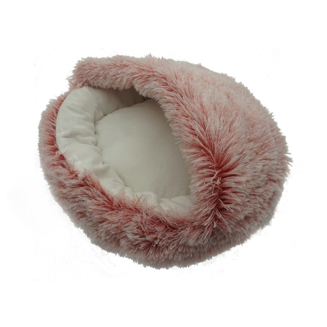 A pink fluffy faux fur pet bed with a cream-colored inner lining, shown on a plain white background.